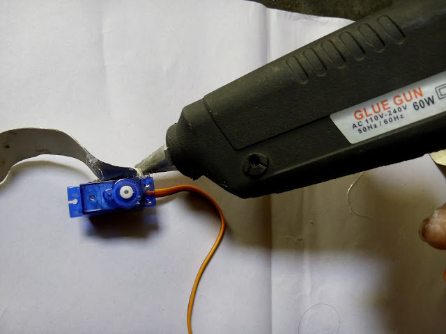 Robotic Arm Gripper use of tool and material